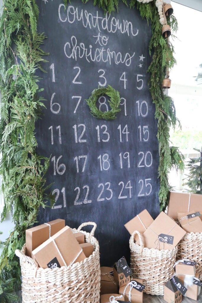 a chalkboard with numbers and wreaths on it is surrounded by boxes, wrapped in twine