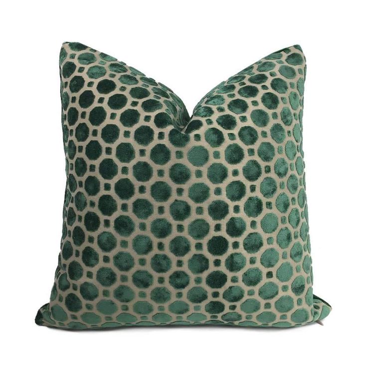 a green and white pillow with circles on it's back, in front of a white background