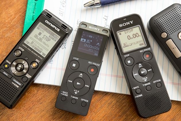 three different types of electronic devices sitting on top of a paper next to a pen