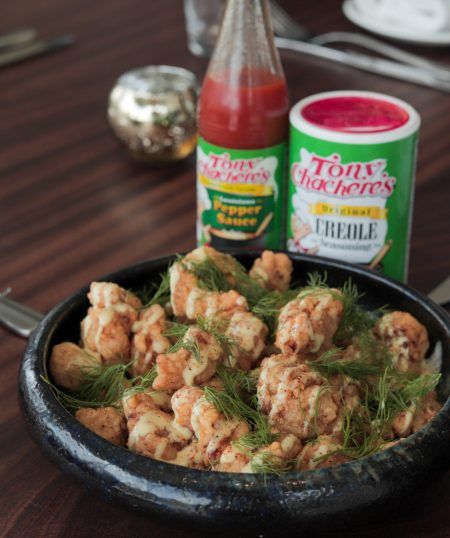 a bowl filled with food next to two cans of ketchup on a table