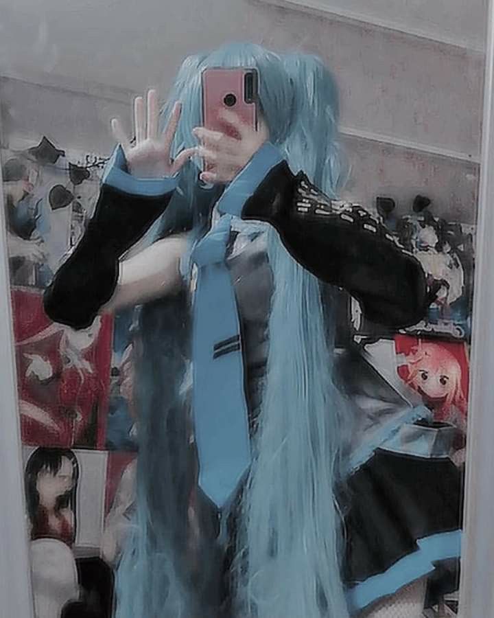 a woman with blue hair taking a selfie