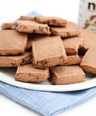 a white plate topped with brownies next to a bottle of milk