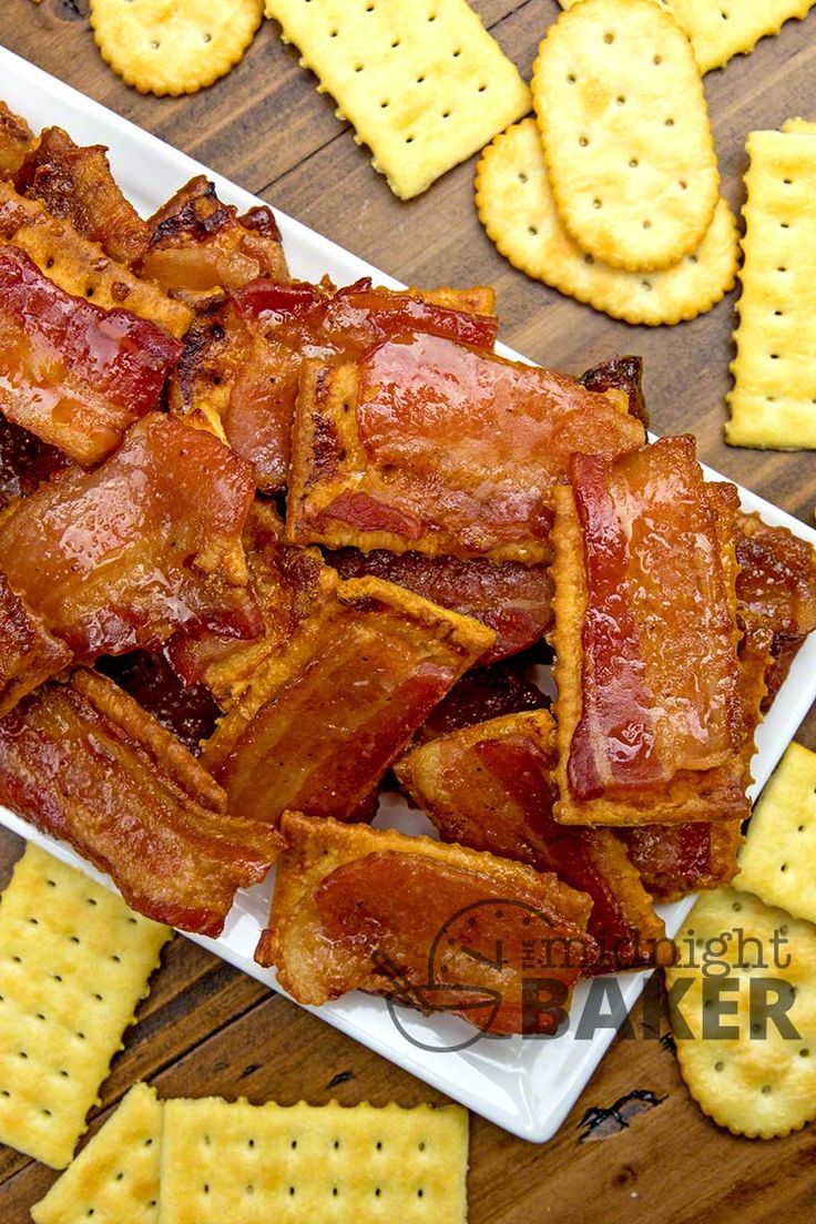 bacon strips and crackers on a plate with cheese sticks in the background, ready to be eaten