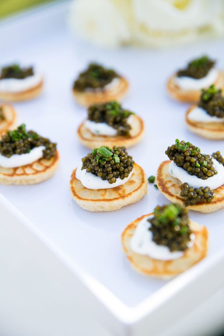 small appetizers are arranged on a white tray