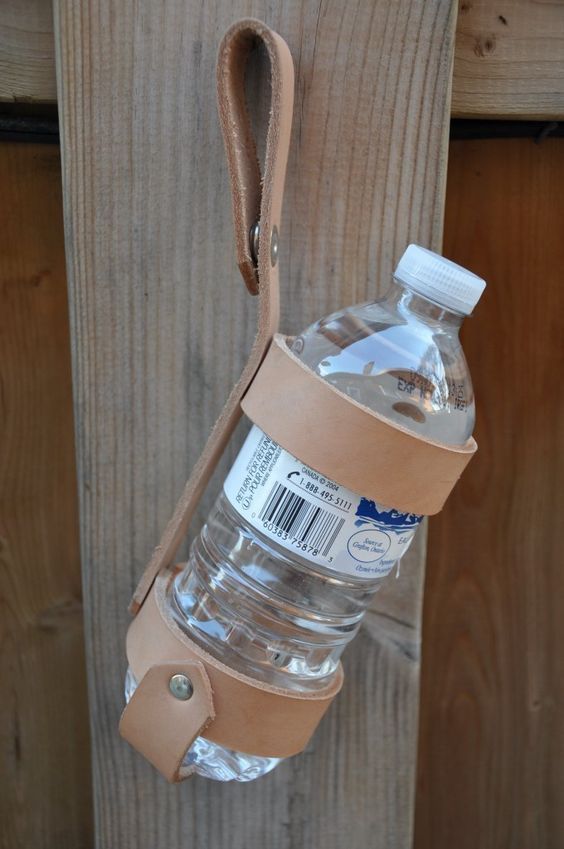 a water bottle hanging from a wooden wall