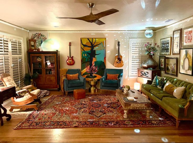 a living room filled with furniture and lots of pictures hanging on the wall above it