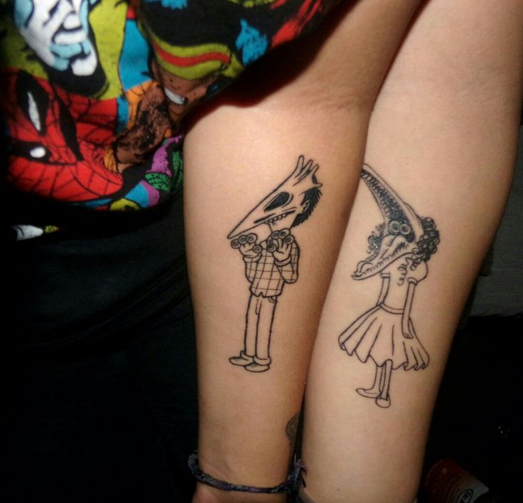 two people with matching tattoos on their arms