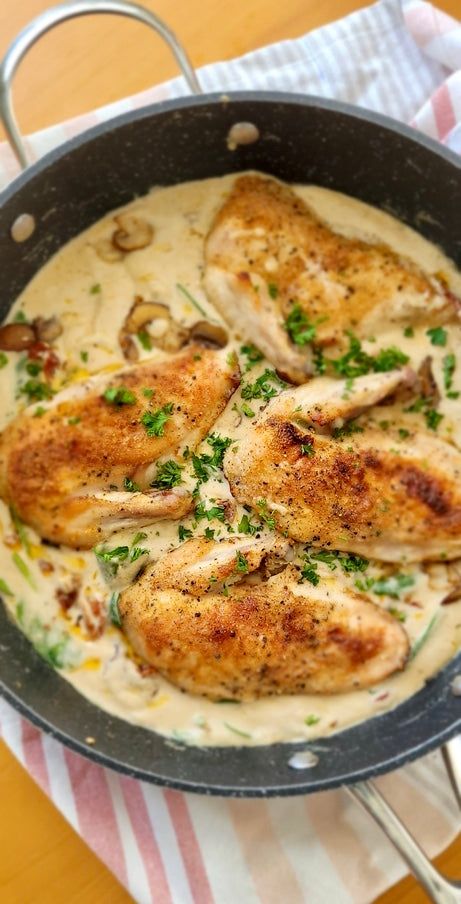 some chicken is cooking in a pan on the table