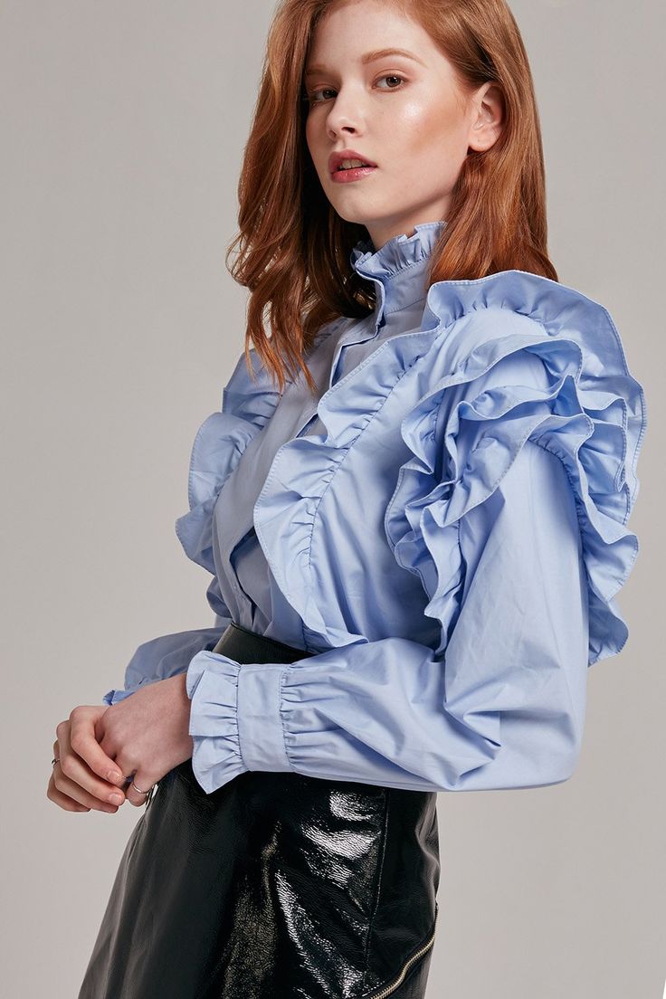 Details This button-up top channels vintage elegance with its high neckline and ruffle details. - High neckline - Ruffles on shoulders and around neck - Button closure in front - Comes in two colors: Skyblue / White Content + Care - 100% Cotton - Dry clean Size + Fit Model is 5'8" and wearing size S Ruffle Outfit, Frilly Blouse, Pretty Blouses, Cute Blouses, Ruffle Collar, Neck Ruffle, Beautiful Blouses, Blouse Dress, Sleeve Designs