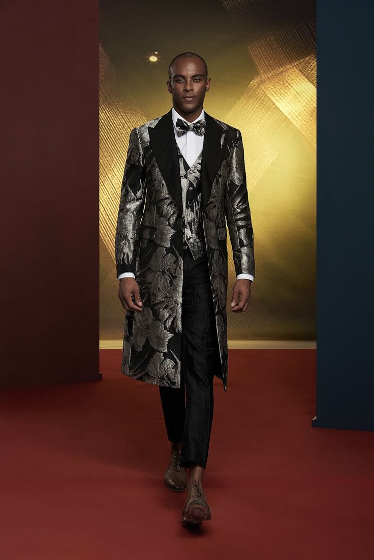 This luxury grey metallic patterned tuxedo for men or women is perfect for exclusive formal events. The three piece extended jacket is a detailed addition to elevate your collection. FREE SHIPPING ON ORDERS OVER $199 COLOR Black/Silver COMPOSITION N/A YARN COUNT N/A WEIGHT 290g FABRIC STYLE Jacquard OCCASION Wedding/Gala Luxury Sets For Black-tie Festive Events, Luxury Festive Sets For Black-tie Events, Luxury Three-piece Suit For Party, Elegant Gray Three-piece Suit, Fitted Silver Blazer For Evening, Luxury Silver Outerwear For Parties, Elegant Black Three-piece Suit For Winter, Elegant Formal Winter Sets, Elegant Holiday Suits