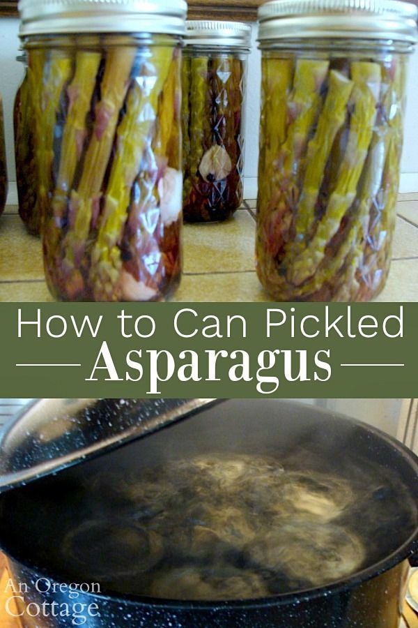 jars filled with pickled asparagus sitting on top of a stove