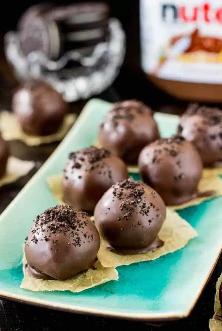 chocolate covered donuts sitting on top of a blue plate