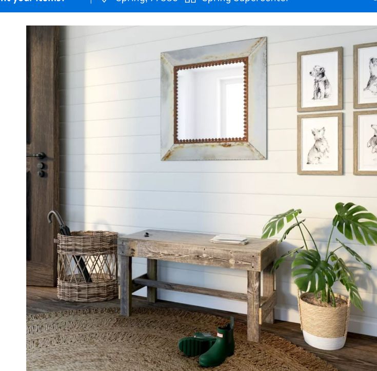 a wooden bench sitting under a mirror next to a potted plant