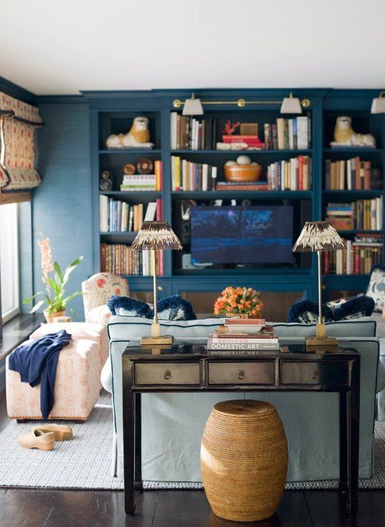 a living room filled with furniture and bookshelves