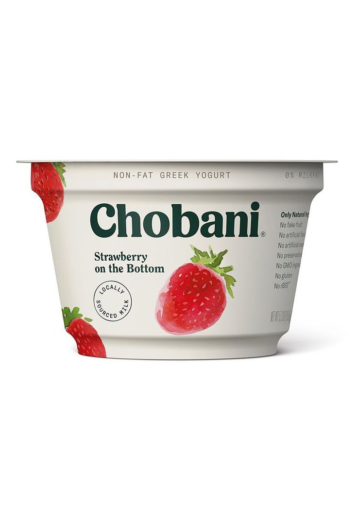 yogurt with strawberries on the bottom is shown in front of a white background