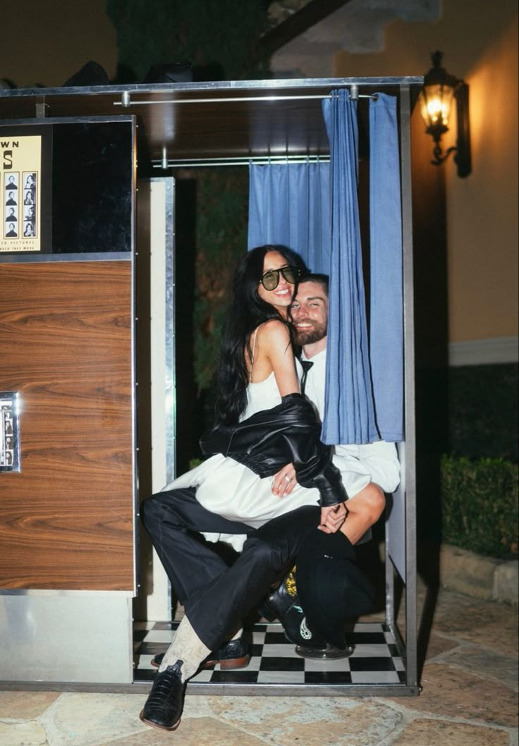 a man and woman are sitting in a booth