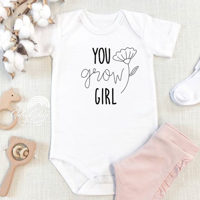 a baby bodysuit with the words you grow girl on it next to cotton flowers