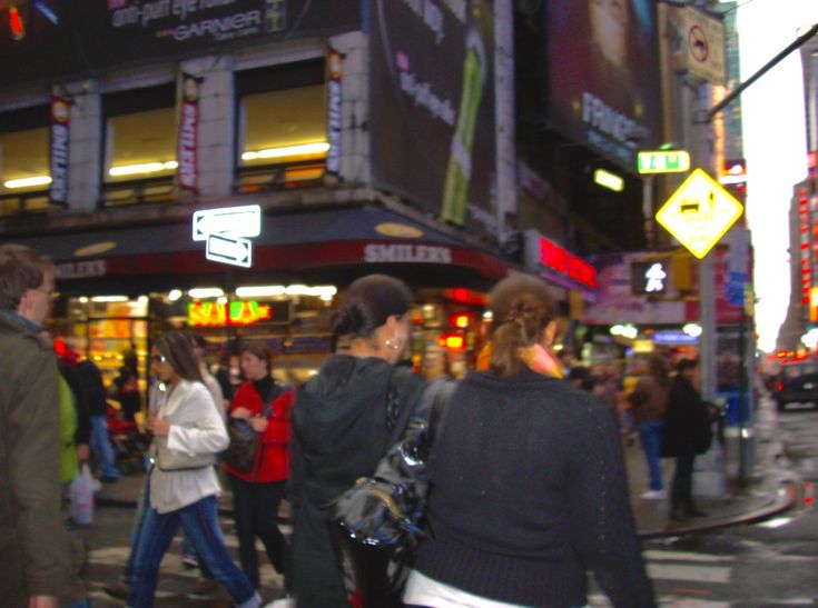 many people are walking on the street in times square