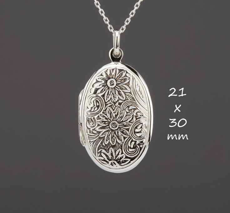 "Carrying the pictures of your loved ones close to your heart all the time, this large oval sterling silver locket necklace features: 1. a large (30 x 21 mm without bale, 7.5 grams), both sides stamped with an ornate daisies (April birth flower)      3. It can hold two pictures inside. Photo insertion service is available for $14 each (selected through the pulldown menu). If you decide to use this service, please attach your locket photos to a conversation.  4. a sterling silver cable chain with Antique Sterling Silver Locket Necklace For Anniversary, Antique Sterling Silver Locket Necklace For Memorial, Antique Sterling Silver Memorial Locket Necklace, Engraved Oval Link Locket Necklace For Wedding, Silver Locket Necklace With Birth Flower Round Pendant, Silver Oval Necklace For Anniversary Gift, Silver Oval Necklace For Anniversary, Antique Sterling Silver Locket Necklace With Oval Pendant, Elegant Oval Locket Necklace For Anniversary