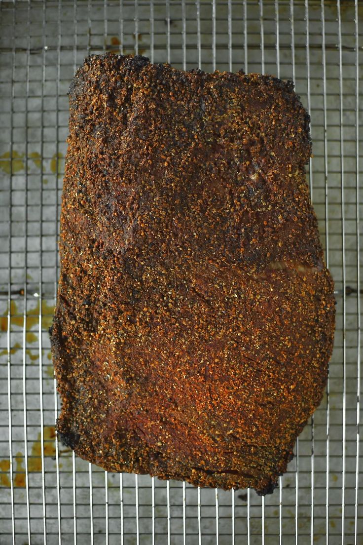 a piece of meat sitting on top of a wire rack