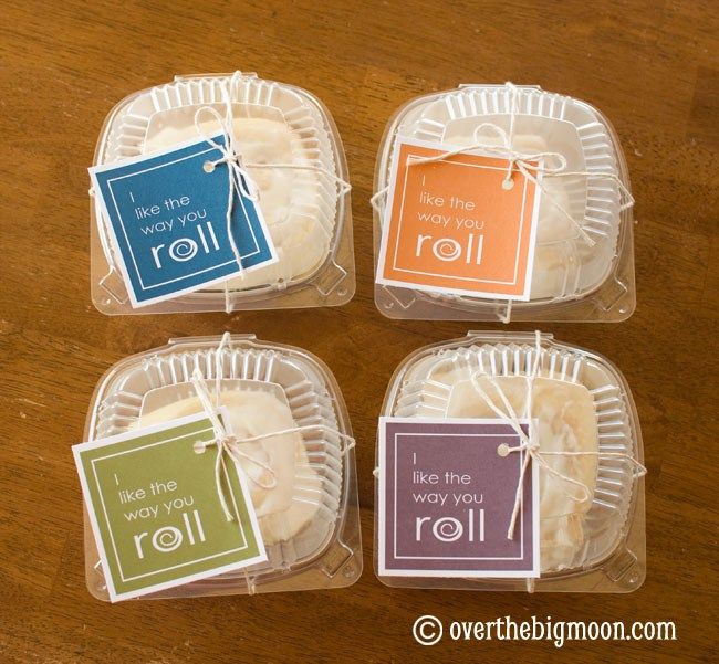 four packaged cookies sitting on top of a wooden table