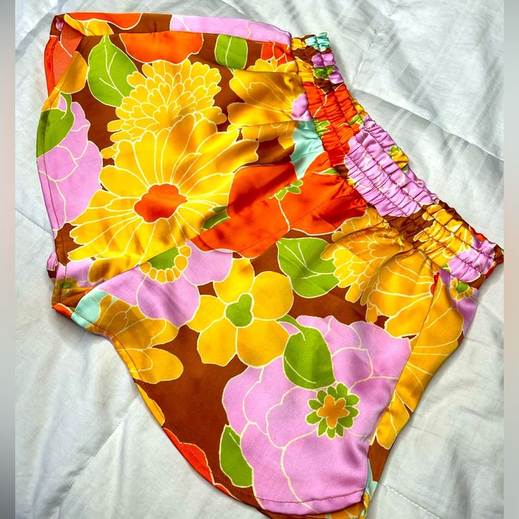 Say Hello To Your New Summer Staple! Large Neon Flowers Decorate These Cute Little Satin Dolphin Shorts. With Elastic At The Waist And Pockets, They Are Made For Having Fun! New Without Tags. Size Xs. Yellow Stretch Shorts For Vacation, Trendy Yellow Shorts For Beach Season, Yellow Beachwear Shorts For Spring, Forever 21 Summer Bottoms With Elastic Waistband, Retro Elastic Waistband Bottoms For Vacation, Fitted Yellow Shorts With Elastic Waistband, Forever 21 Beach Shorts For Summer, Forever 21 Shorts For Beach In Summer, Forever 21 Bottoms For Beach Vacation