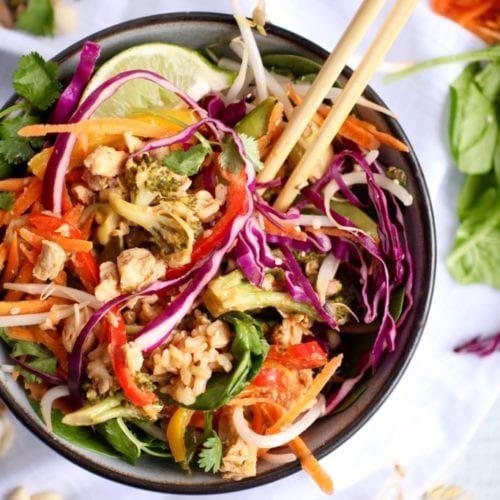 a salad with carrots, lettuce, and other vegetables in a bowl