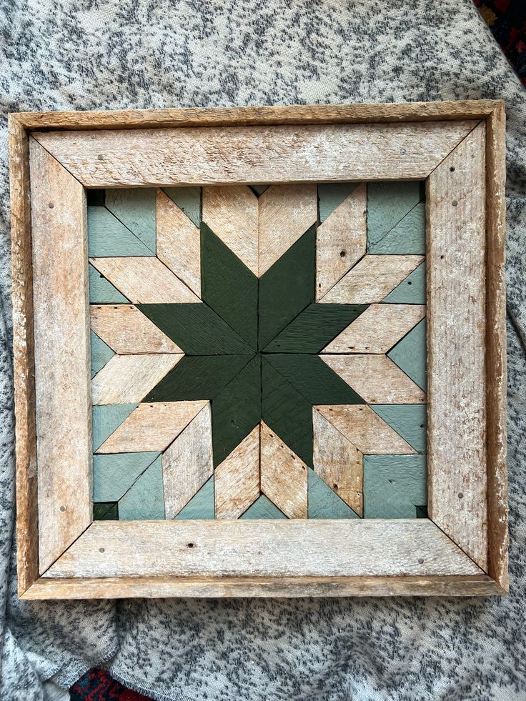 a wooden frame with a green star on it