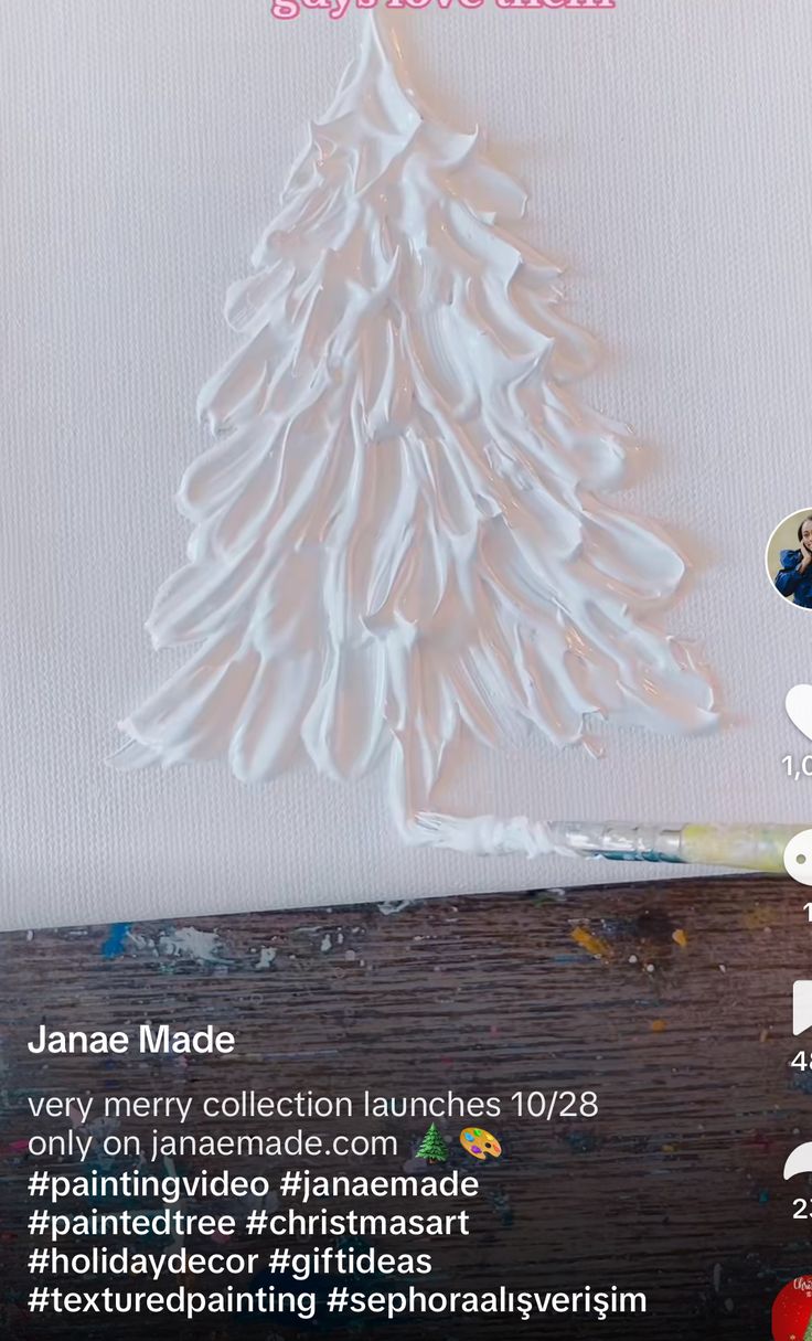 a white christmas tree sitting on top of a wooden table