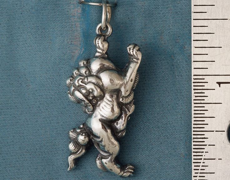 In many parts of Asia, Fu dogs are believed to be guardians who protect temples, homes and palaces against evil spirits. My solid sterling silver Fu dog is shown, but I also make them in solid bronze. I reproduced and adapted my Fu dog pendant from a Japanese samurai sword fitting.  My Fu dog is about 1 1/4 inches from the tip of his tail to the tip of his front paw. I made him using the lost wax casting process.  All my pendants come with an adjustable black silky cord. For more information on Sparkly Birthday, Celtic Triangle, Guardian Lion, Fu Dog, Art Nouveau Pendant, Lion Dog, Sparkly Wedding, Dog Charm, Crystal Bead Necklace