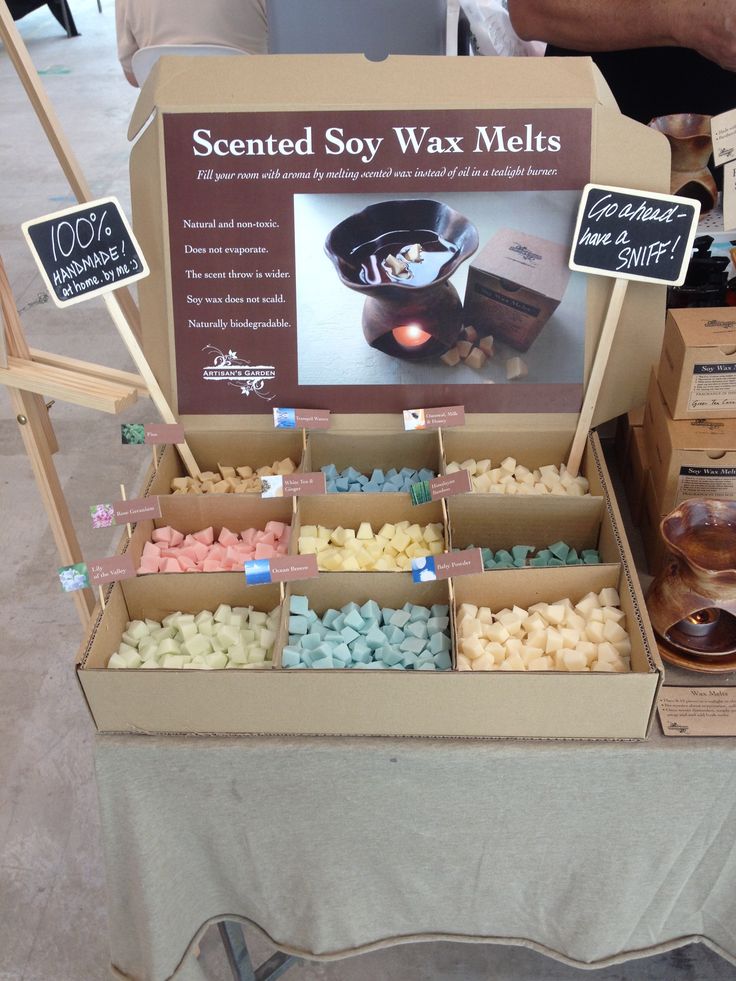 a table with many different types of wax and candles on it, including soaps