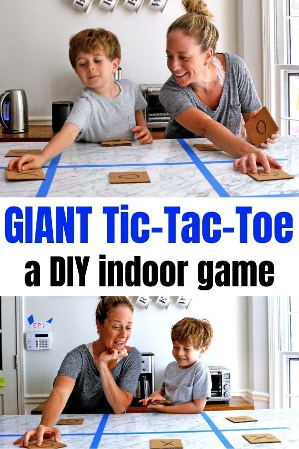 two kids and an adult playing with giant tic - tac toe board game