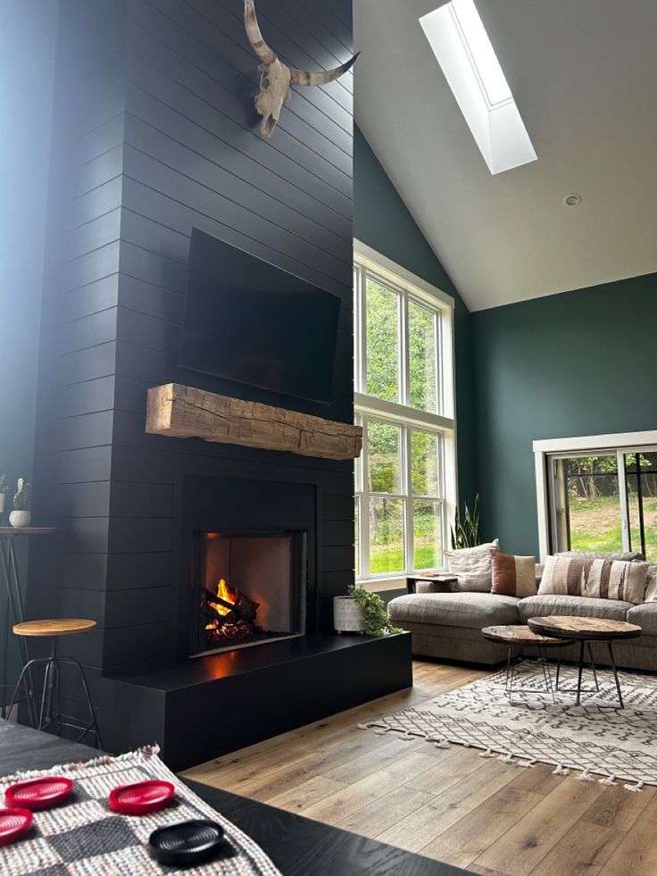 a living room filled with furniture and a fire place next to a large open window