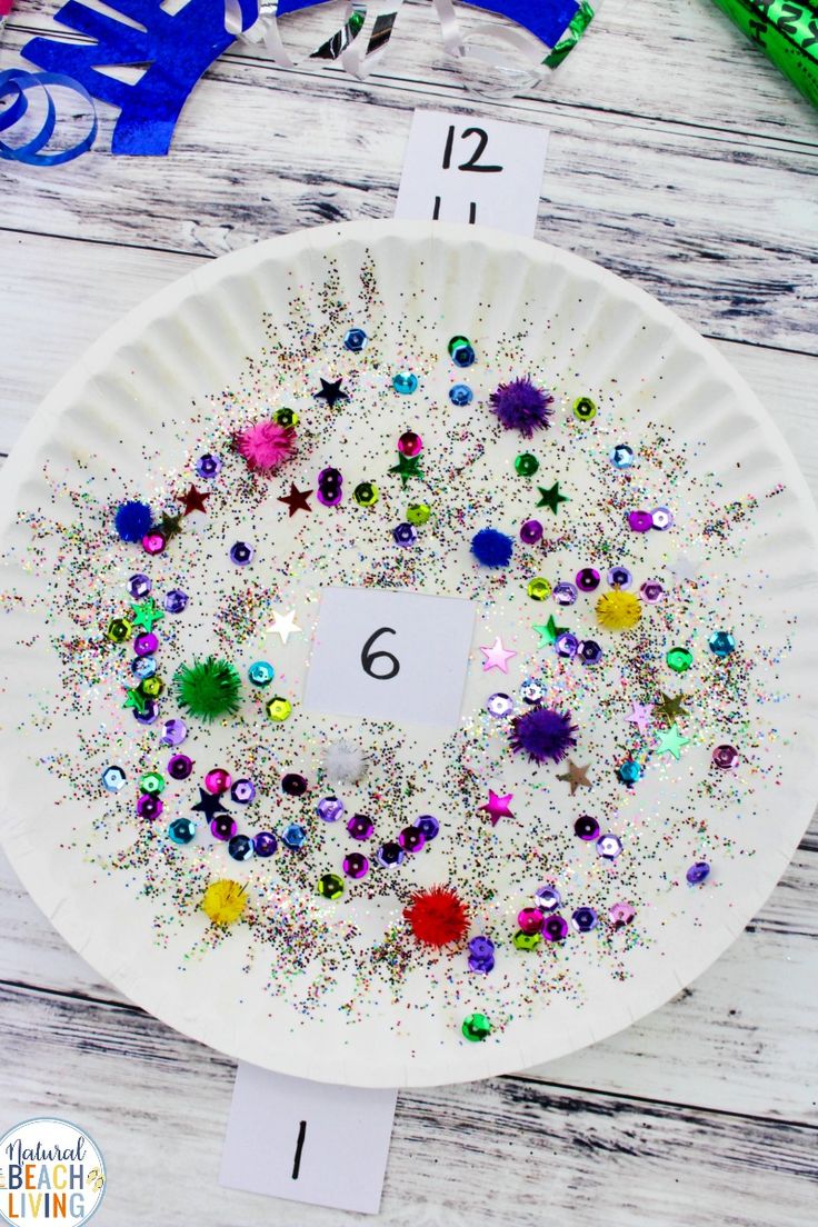 a paper plate with glitter and numbers on it