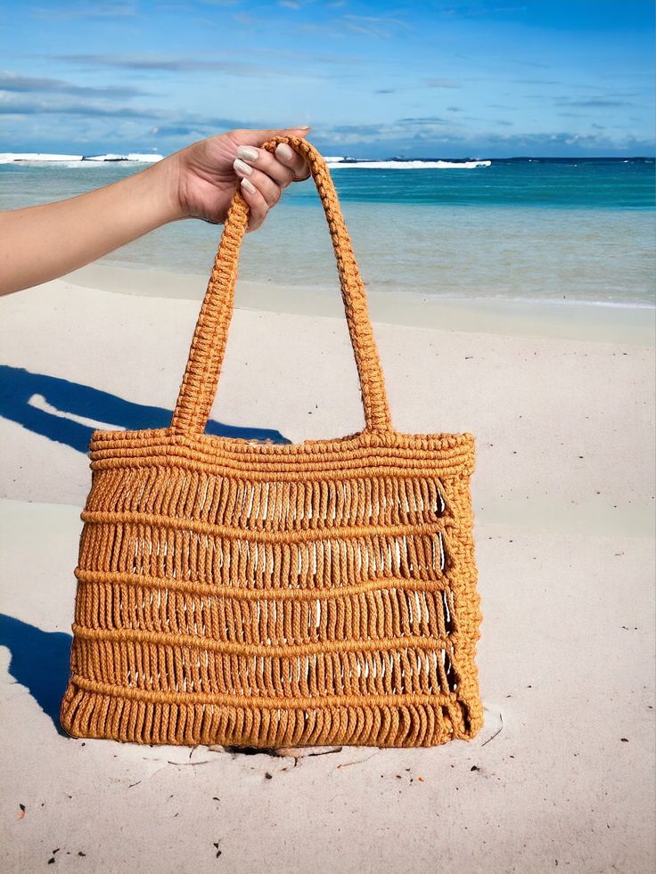 "Introducing our stunning Tote Bag - a chic and stylish accessory that's sure to elevate any outfit! This beautiful bag boasts intricate macrame ornamentation that adds a touch of boho flair to your look.  Not only is this tote bag a fashion statement, but it's also practical and roomy enough to hold all your essentials. Whether you're headed to work, the beach for a picnic, or out for a shopping spree, this tote bag has got you covered. Our Tote Bag is handmade with love and attention to detail, ensuring that each bag is of the highest quality. And when it comes to care, it's a breeze - just dry clean as needed! So why wait? Add this beautiful bag to your collection today!" Chic Braided Tote Beach Bag, Bohemian Straw Shoulder Bag With Braided Handles, Bohemian Crochet Bag With Adjustable Strap For Day Out, Bohemian Woven Bag For Day Out, Bohemian Brown Braided Beach Bag, Bohemian Braided Brown Beach Bag, Chic Brown Braided Beach Bag, Spring Bohemian Open Weave Shoulder Bag, Beige Macrame Straw Bag For Vacation