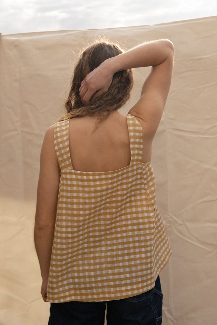 Simple square neck tank top, with square chest pocket. Hip length. The block printed gingham imbues an organic, rustic charm unique to wooden blocks and skilled hands. Model is size UK 10, US 6. Both models are 5'8 tall, size UK 10, US 6 and are wearing the S. Suitable for sizes UK 8-16, US 4-12. Each order comes with a free A5 BANJAARA slow living inspired illustration. Printed onto 100% cotton. Plant-based dyes. The block printing process is all done by the artisan’s hand – natural imperfectio Everyday Cotton Tank Top With Square Neck, Cotton Square Neck Tank Top For Everyday, Square Neck Cotton Tank Top For Everyday, Everyday Plaid Summer Tops, Plaid Tops For Everyday Summer Wear, Everyday Cotton Square Neck Top, Cotton Sleeveless Tank Top For Picnic, Everyday Cotton Top With Square Neck, Square Neck Cotton Top For Everyday