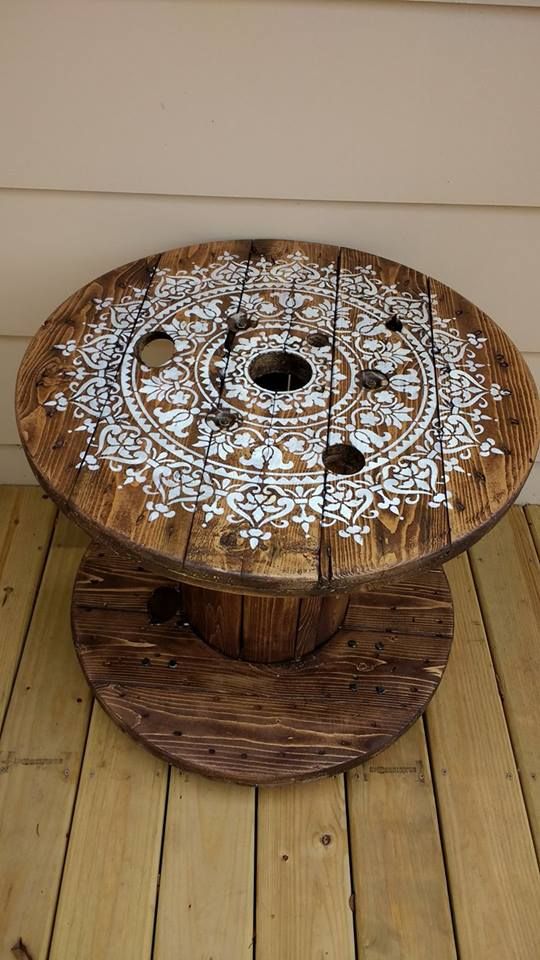 a wooden table with white designs on it