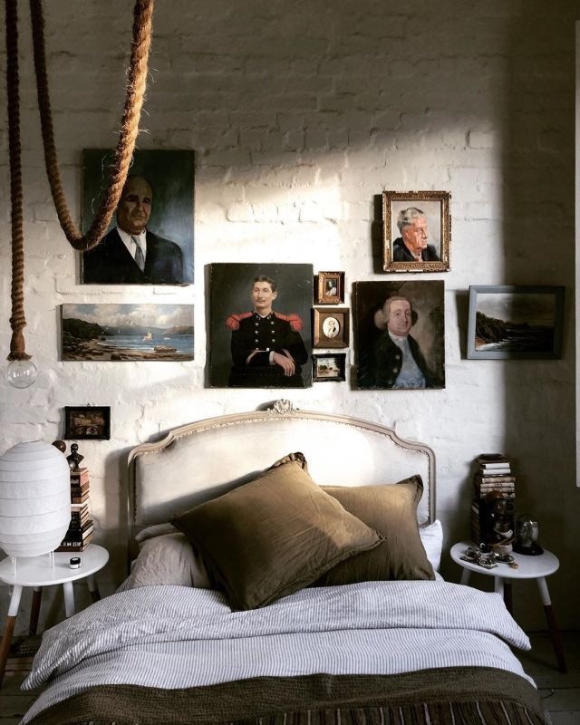 a bedroom with pictures on the wall above the bed