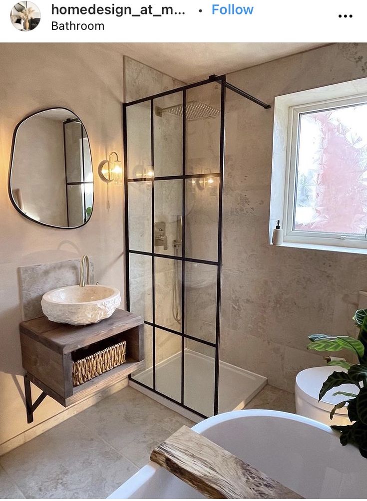 a bathroom with a sink, mirror and tub in it's own area next to a window