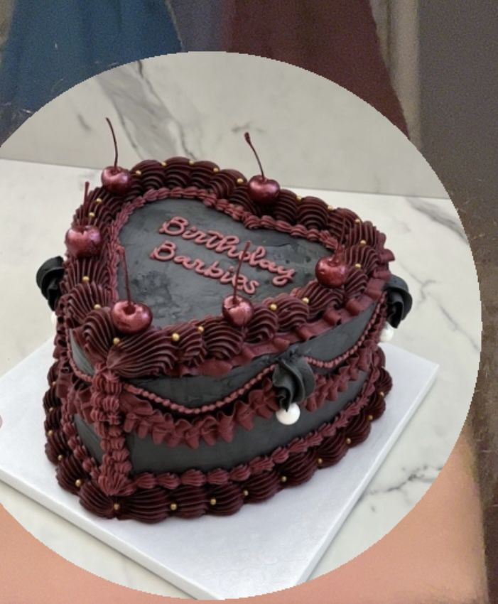 a heart shaped birthday cake on top of a table