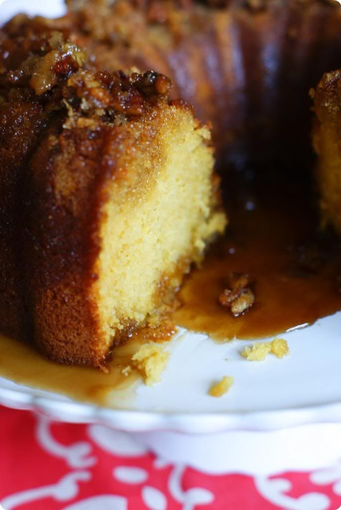 a bundt cake on a plate with one slice cut out and the rest half eaten