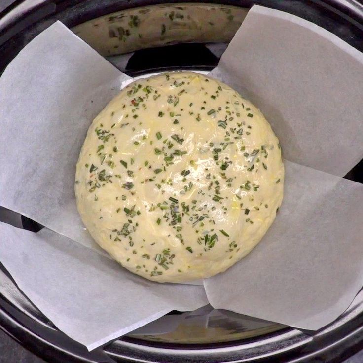 a food item in a bowl with wax paper on the bottom and napkins around it