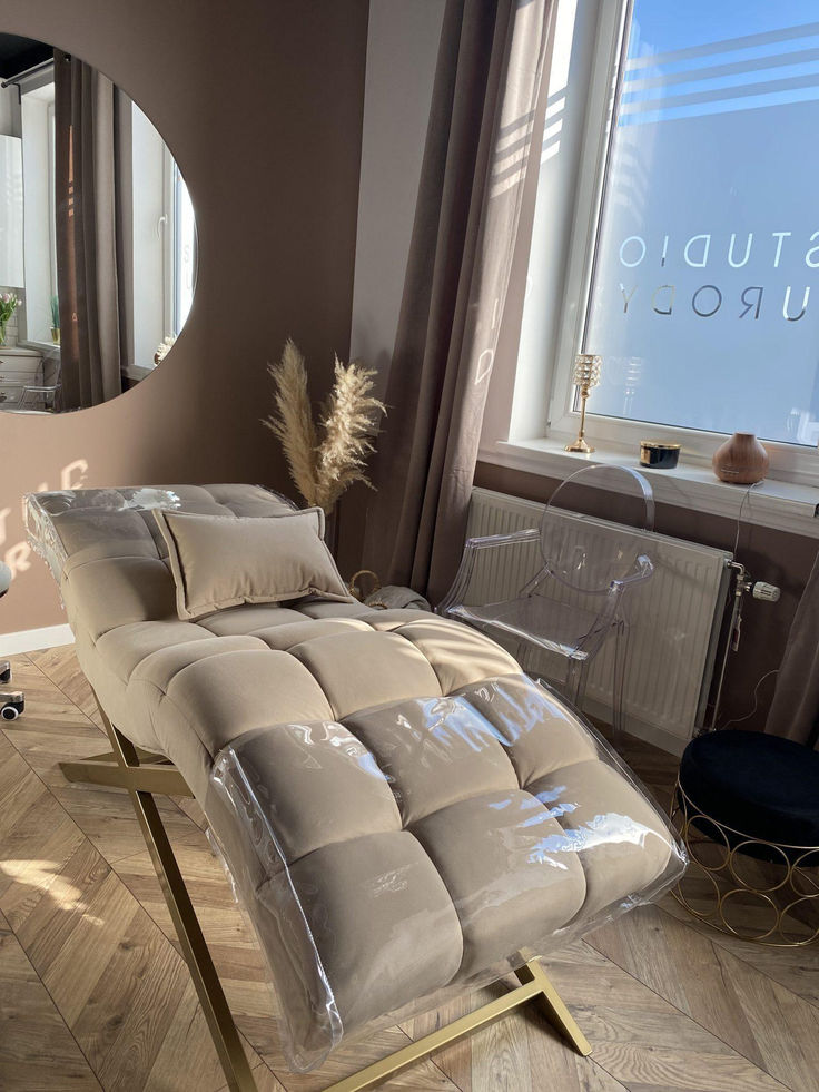 a bed sitting on top of a hard wood floor next to a mirror and window