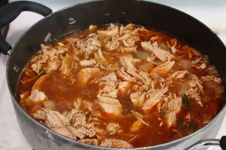 a pot filled with soup sitting on top of a stove