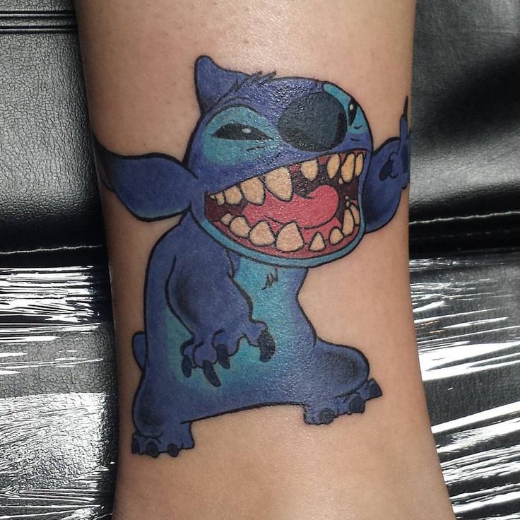 a tattoo with a cartoon character on it's leg and the word stitcher written in