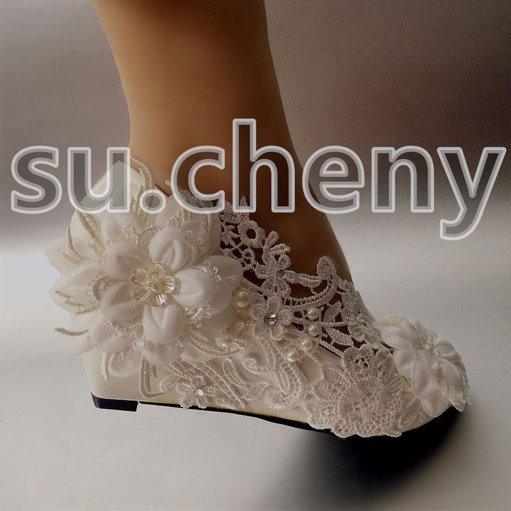 there is a woman's shoe with flowers on the bottom and lace around the heel