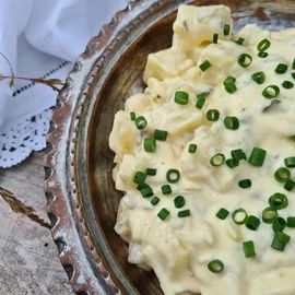 a bowl filled with mashed potatoes and green onions