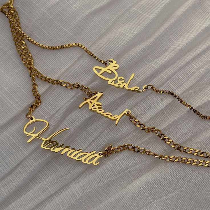 Personalize your style with our Mini Dainty Cuban Name Necklace, crafted from high-quality gold or silver-plated stainless steel. Delicately designed, this necklace features your name elegantly spelled out, adding a touch of personality to any look. The adjustable chain ensures the perfect fit, making it a versatile accessory for any neckline. Whether you're treating yourself or gifting it to someone special, our Custom Dainty Cuban Name Necklace is the perfect way to celebrate individuality and style. Make a statement with a personalized touch that's sure to be cherished for years to come. Stainless Steel 18k Gold, Silver or Rose Gold Plated Waterproof and Tarnish-free Choose your own font style HOW TO ORDER IN 3 EASY STEPS Choose your necklace color and chain length. Chains include a 2 i Elegant Personalized Stainless Steel Chain Necklace, Elegant Personalized Metal Chain Necklace, Elegant Silver Chain Necklace With Custom Name, Gold Stainless Steel Necklace For Wedding, Elegant Personalized Metal Name Necklace, Personalized Metal Pendant Name Necklace, Personalized Metal Pendant Necklace, Custom Name Gold Plated Necklace As Personalized Gift, Custom Name Gold Plated Nameplate Necklace