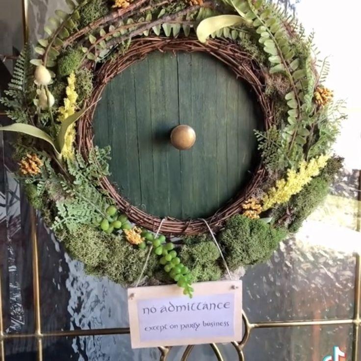 a green door with a wreath on it and a sign that says no admittance