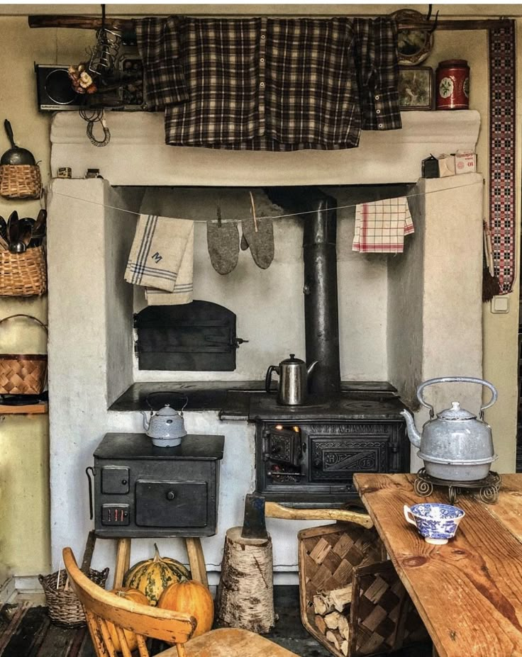 an old fashioned stove and table in a kitchen